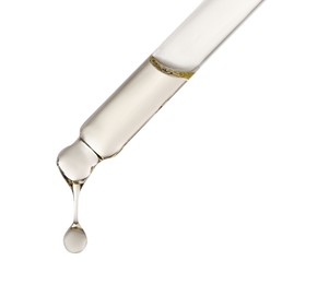 Photo of Essential oil dripping from pipette against white background