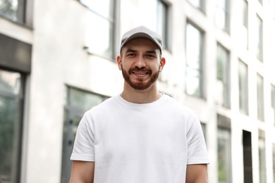 Portrait of smiling man in baseball cap outdoors