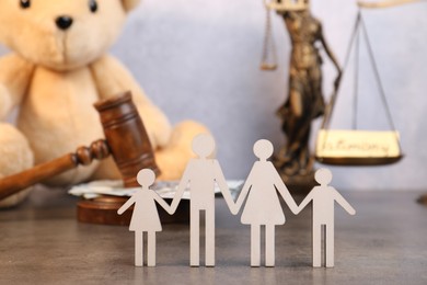 Photo of Alimony concept. Figures of family on grey table, closeup