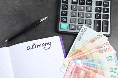 Photo of Notebook with word Alimony, euro banknotes, calculator and pen on grey table, flat lay