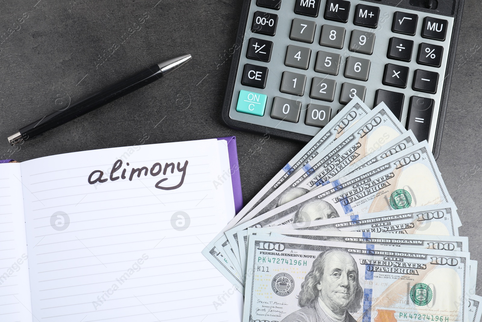 Photo of Notebook with word Alimony, dollar banknotes, calculator and pen on grey table, flat lay