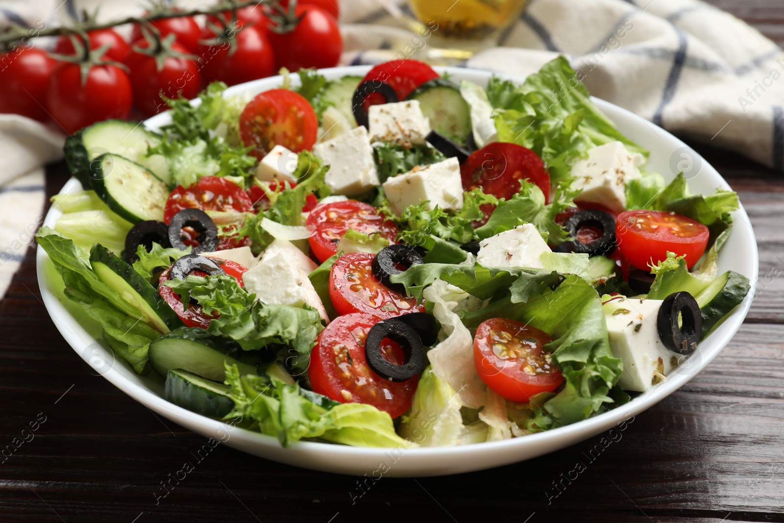 Photo of Delicious salad with feta cheese on wooden table, closeup