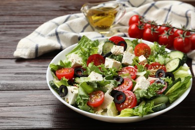 Delicious salad with feta cheese on wooden table, closeup