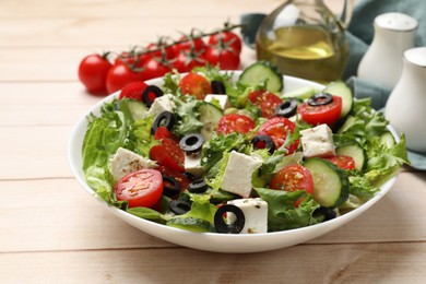 Photo of Delicious salad with feta cheese on white wooden table, closeup