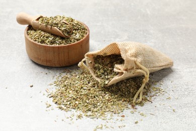 Photo of Dried oregano on grey table. Aromatic spice