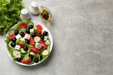 Photo of Delicious salad with feta cheese served on grey table, top view. Space for text