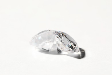 Photo of Two beautiful shiny diamonds on white background, closeup