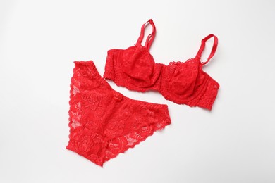 Photo of Elegant red lace women's underwear on white background, top view