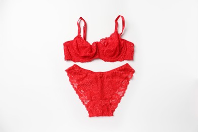 Photo of Elegant red lace women's underwear on white background, top view