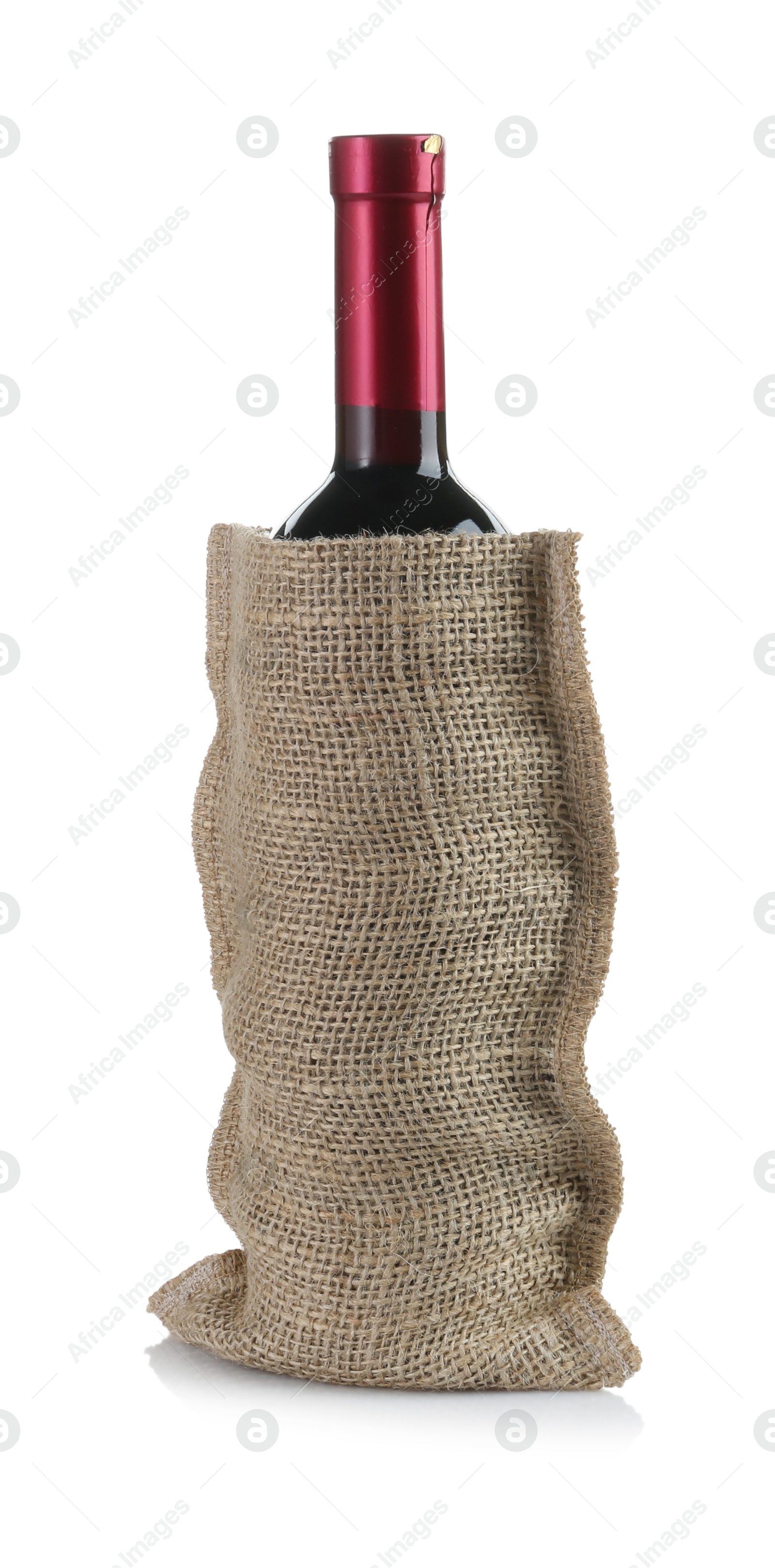 Photo of Wine bottle in burlap bag isolated on white