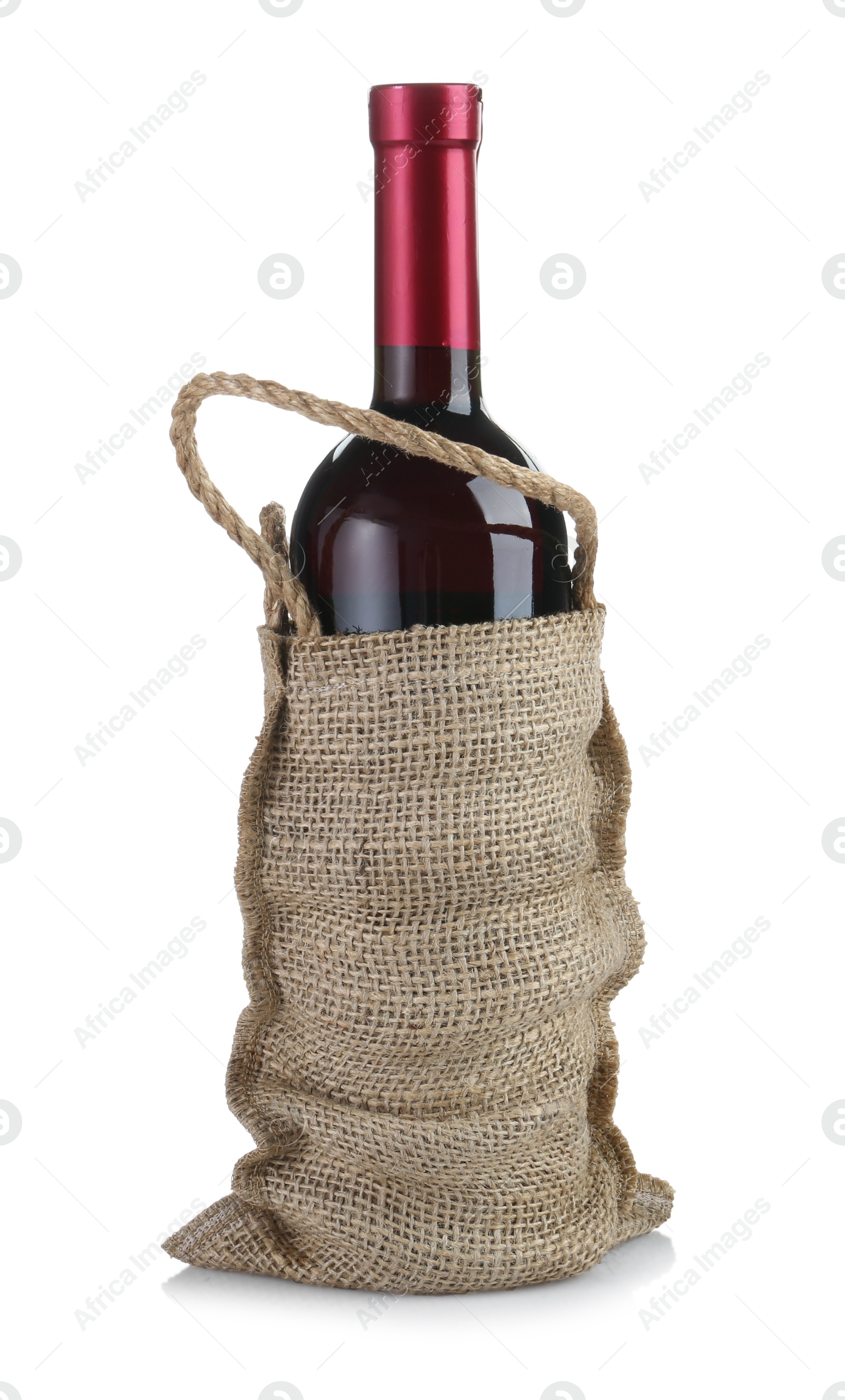 Photo of Wine bottle in burlap bag isolated on white