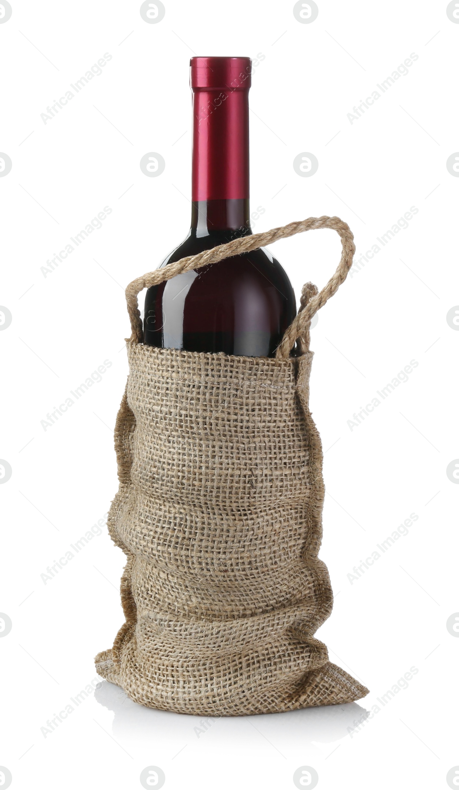 Photo of Wine bottle in burlap bag isolated on white