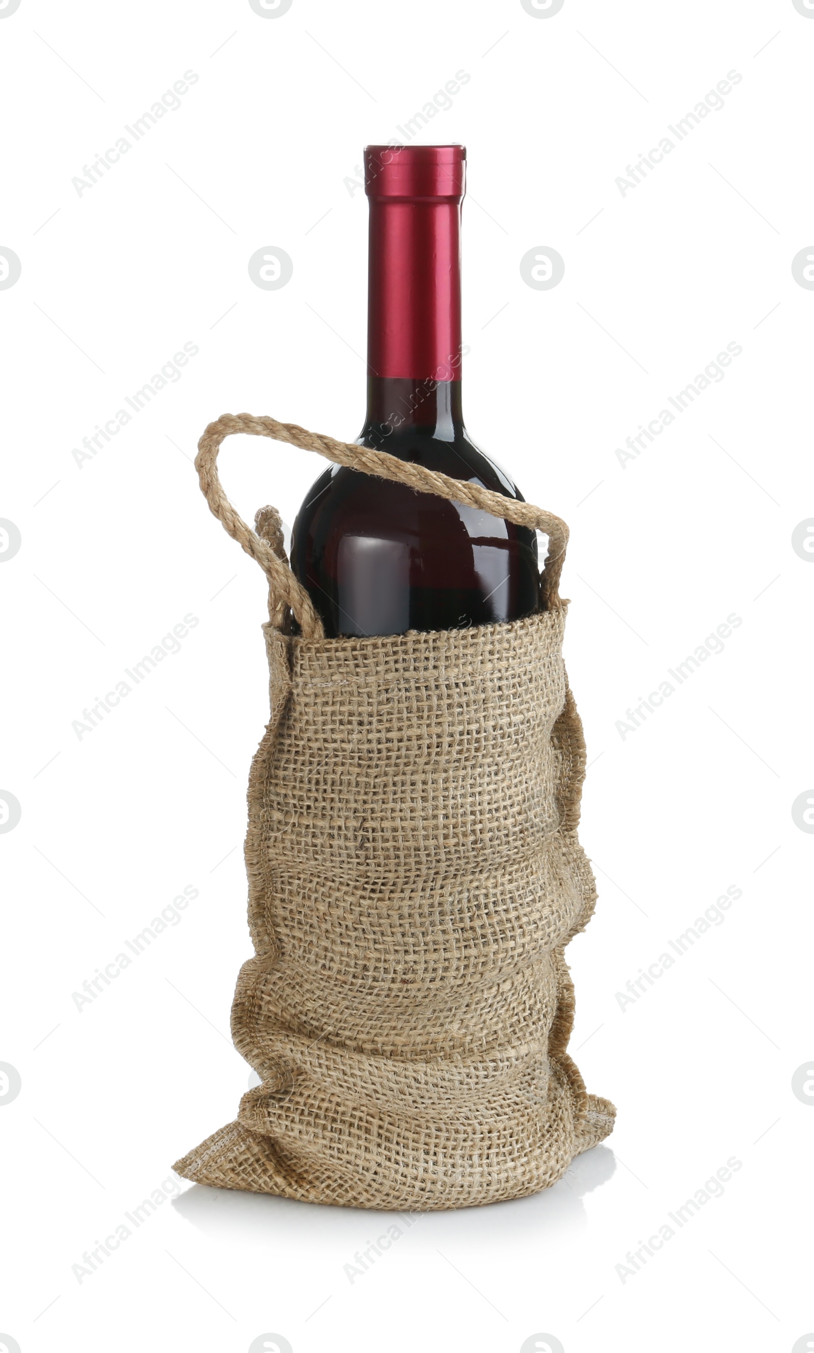 Photo of Wine bottle in burlap bag isolated on white