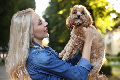 Photo of Beautiful young woman with cute dog in park