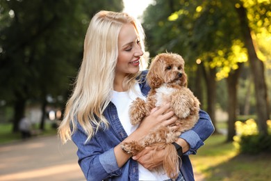 Photo of Beautiful young woman with cute dog in park