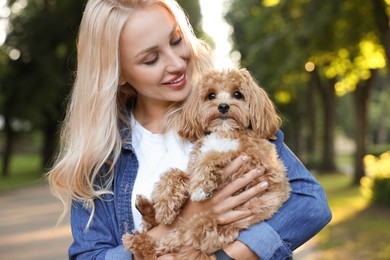 Photo of Beautiful young woman with cute dog in park