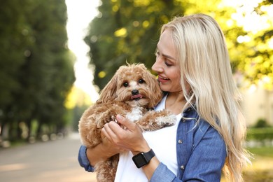 Photo of Beautiful young woman with cute dog in park