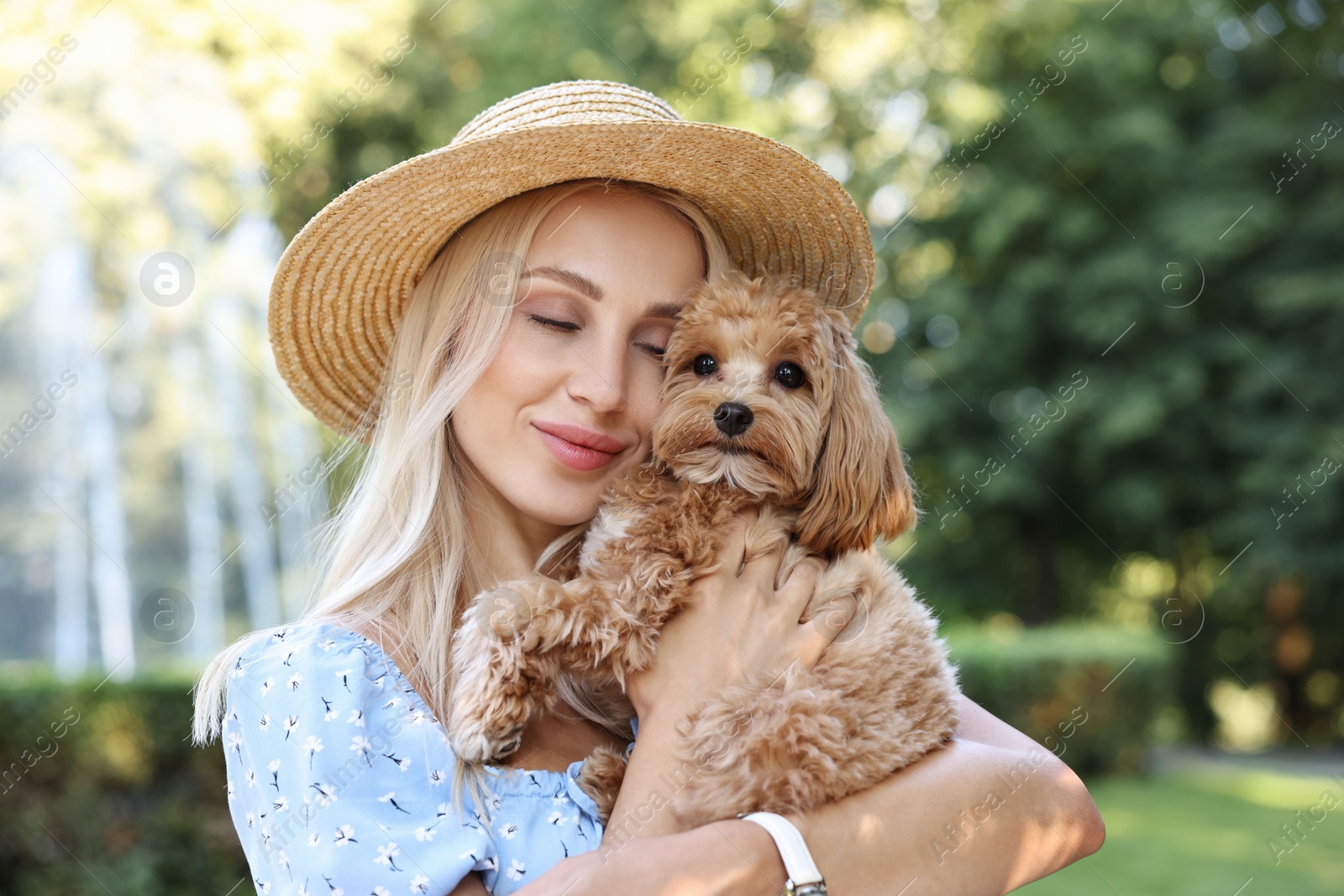 Photo of Beautiful young woman with cute dog in park