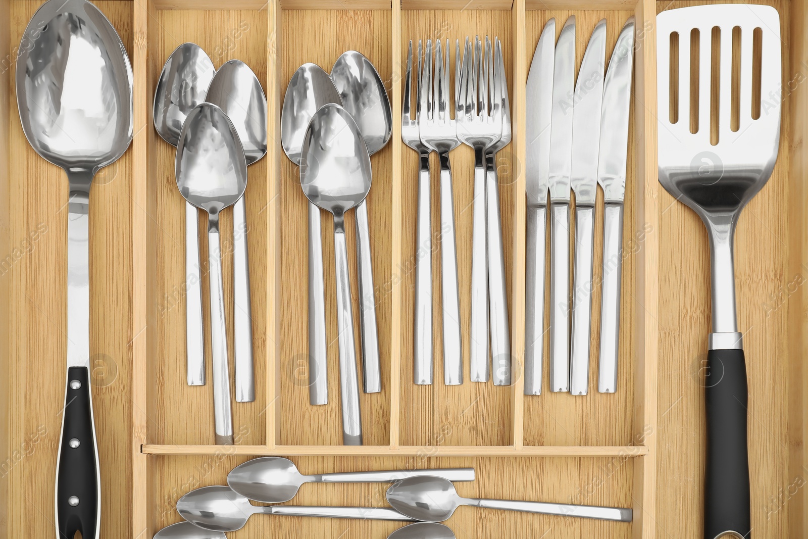 Photo of Box with cutlery in drawer, top view. Kitchen utensils storage