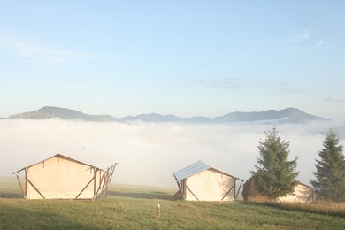 Many houses and beautiful mountains covered with fog in morning