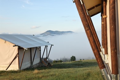 Photo of House and beautiful mountains covered with fog in morning