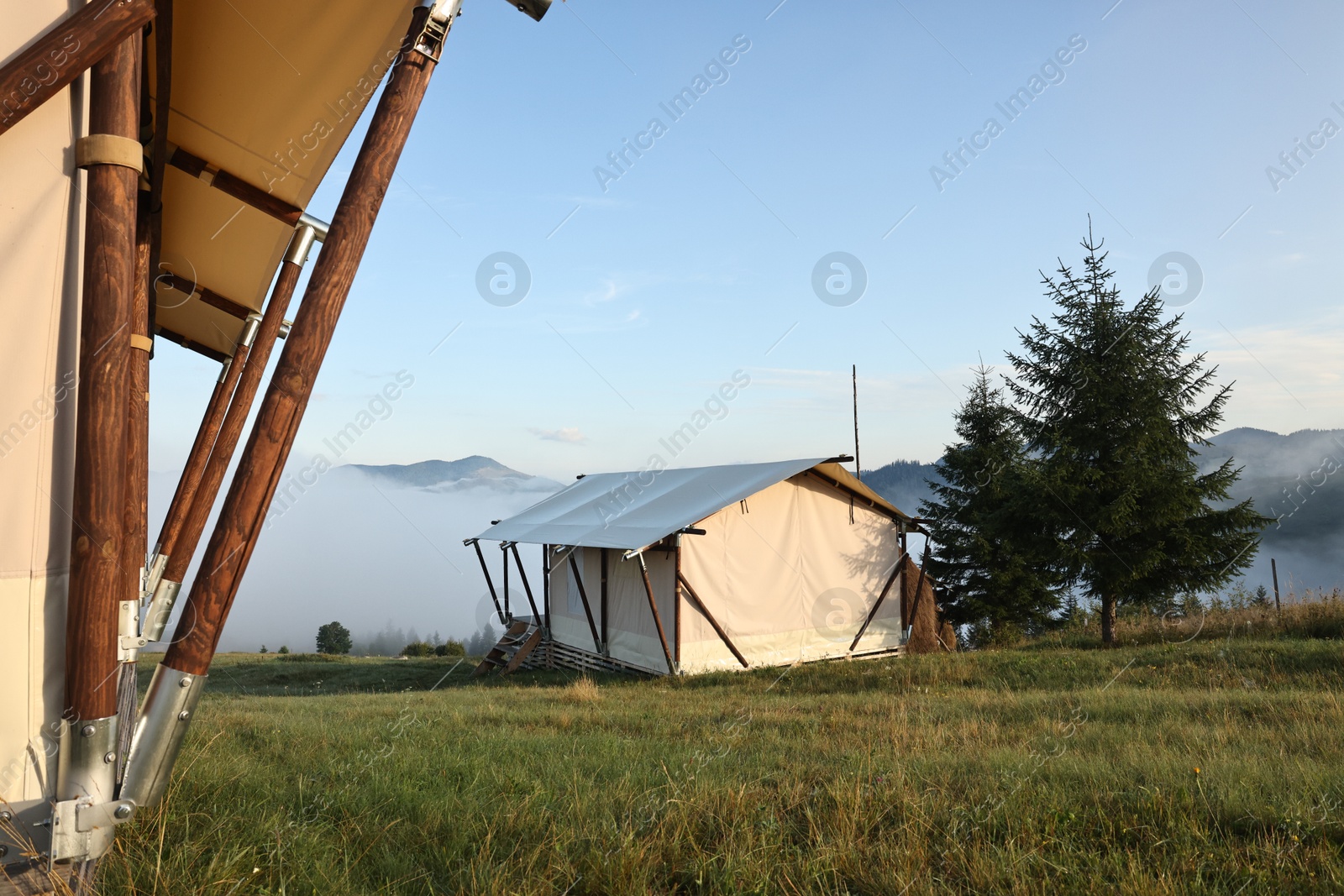 Photo of House and beautiful mountains covered with fog in morning