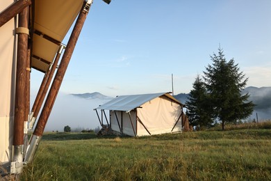 House and beautiful mountains covered with fog in morning