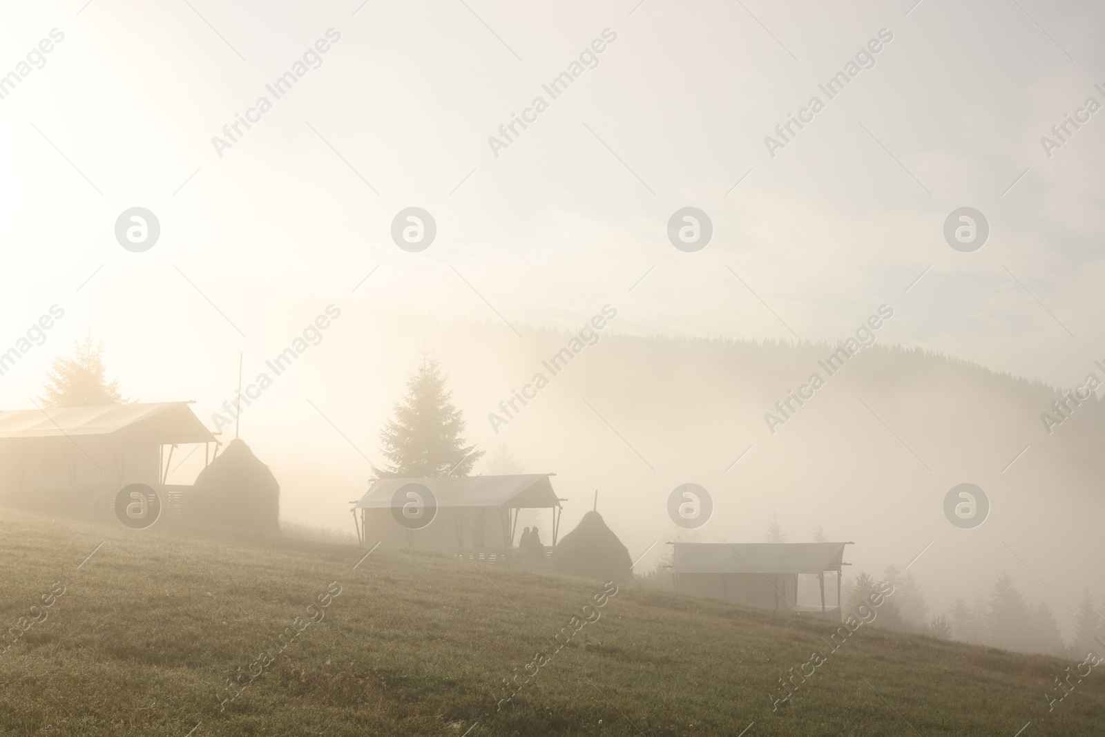 Photo of Many houses and beautiful mountains covered with fog in morning