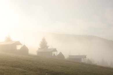 Many houses and beautiful mountains covered with fog in morning