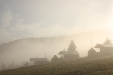 Many houses and beautiful mountains covered with fog in morning