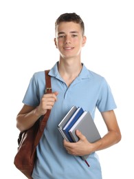 Portrait of teenage boy with backpack and books on white background