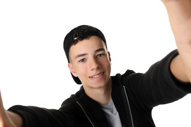 Teenage boy taking selfie on white background