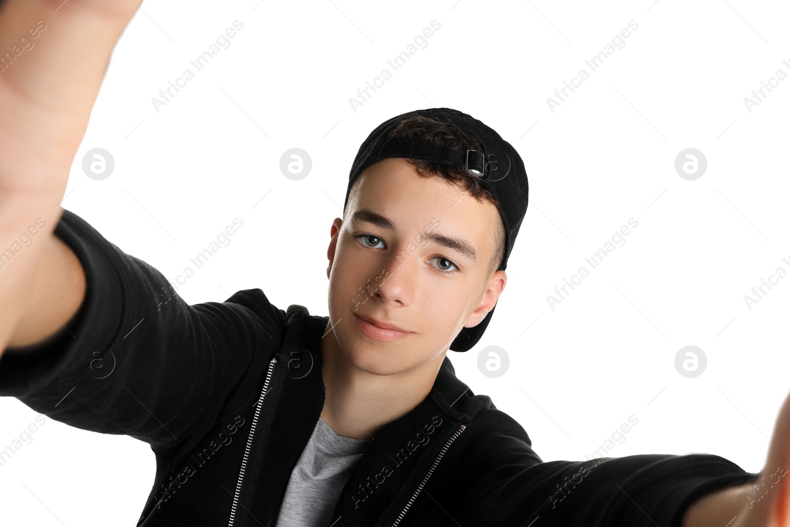 Photo of Teenage boy taking selfie on white background