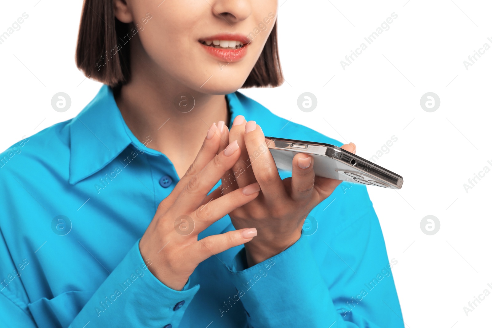 Photo of Woman recording voice message via smartphone on white background, closeup