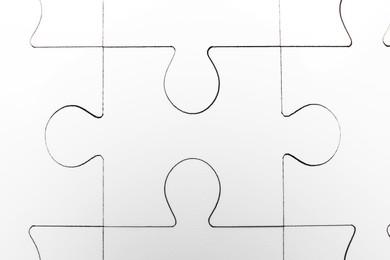 Photo of White puzzle as background, top view. Intellectual game