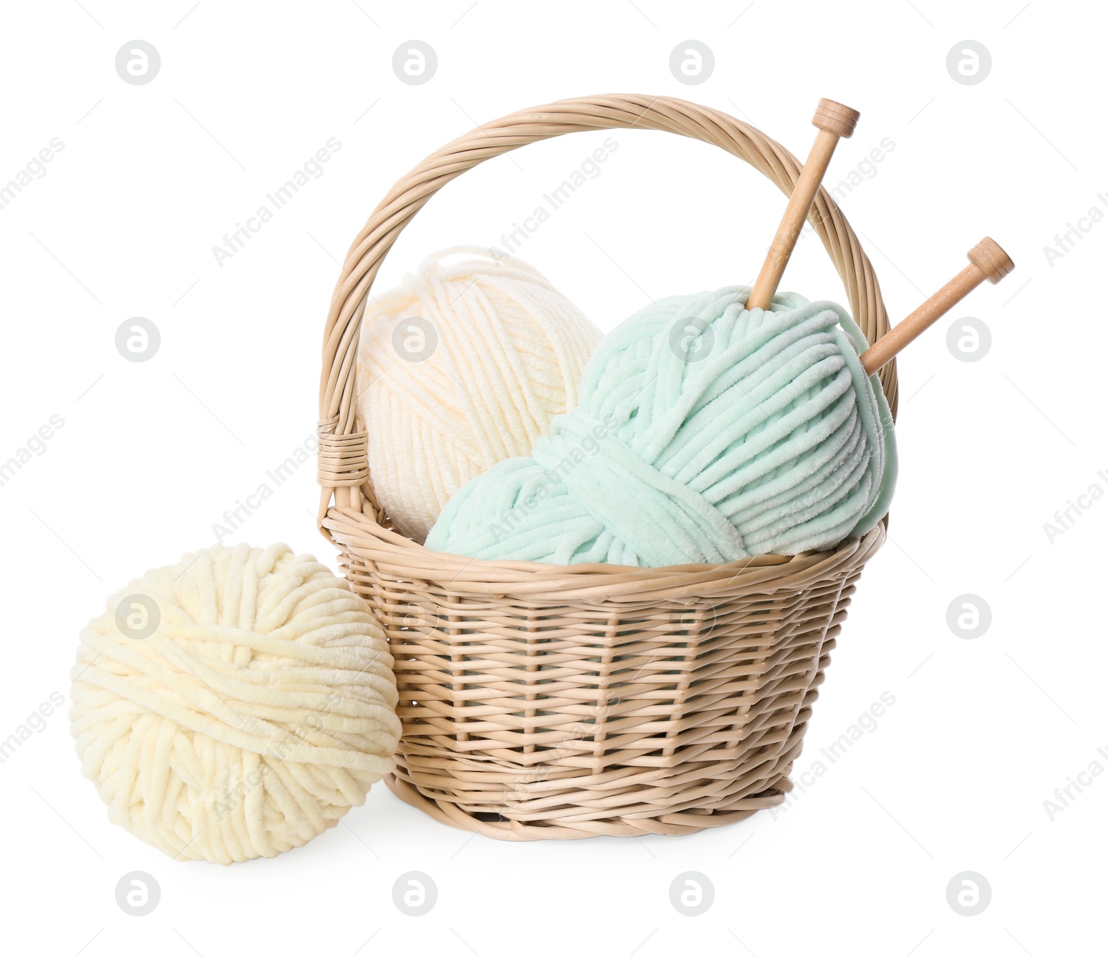 Photo of Skeins of soft yarn and knitting needles isolated on white