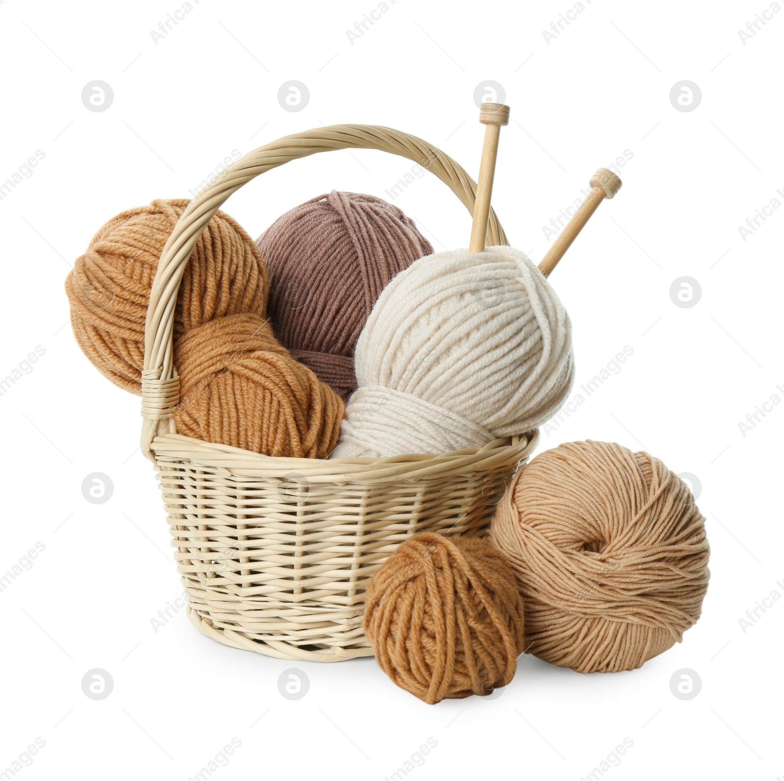 Photo of Skeins of soft yarn and knitting needles isolated on white