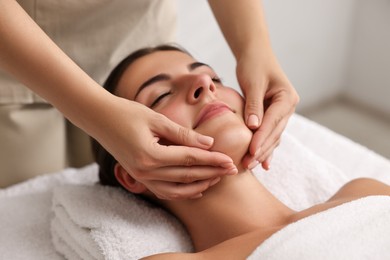 Photo of Attractive woman enjoying face massage, closeup. Beauty procedure