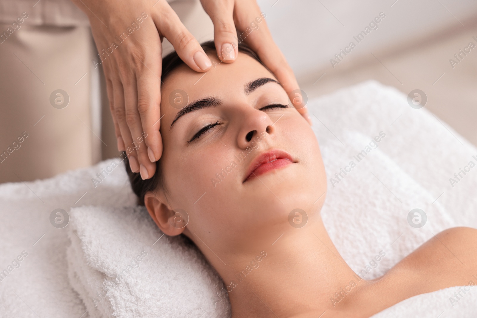 Photo of Attractive woman enjoying face massage, closeup. Beauty procedure