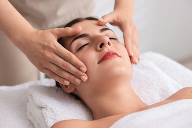 Photo of Attractive woman enjoying face massage, closeup. Beauty procedure