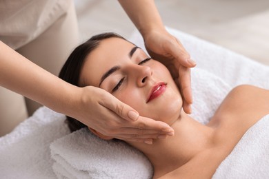 Photo of Attractive woman enjoying face massage, closeup. Beauty procedure