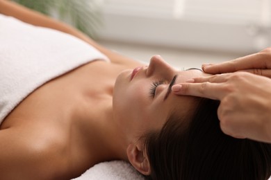 Photo of Attractive woman enjoying face massage, closeup. Beauty procedure