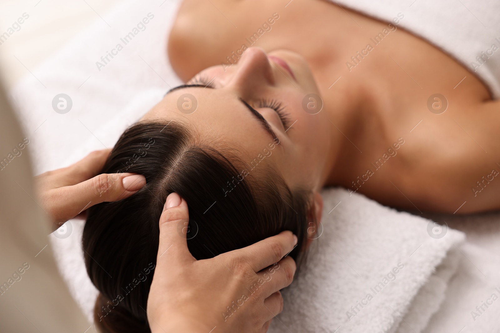 Photo of Attractive woman enjoying face massage, closeup. Beauty procedure