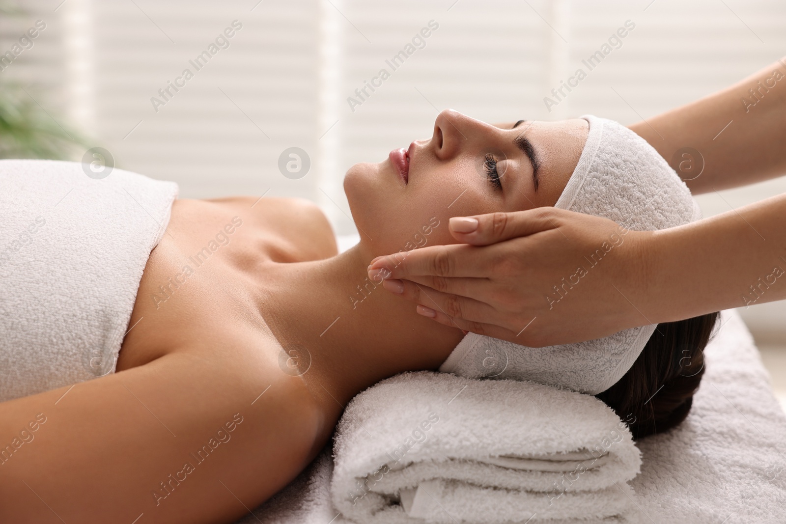 Photo of Attractive woman enjoying face massage, closeup. Beauty procedure