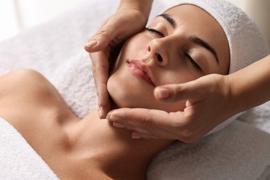 Photo of Attractive woman enjoying face massage, closeup. Beauty procedure