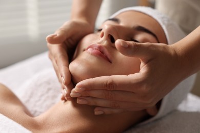 Photo of Attractive woman enjoying face massage, closeup. Beauty procedure