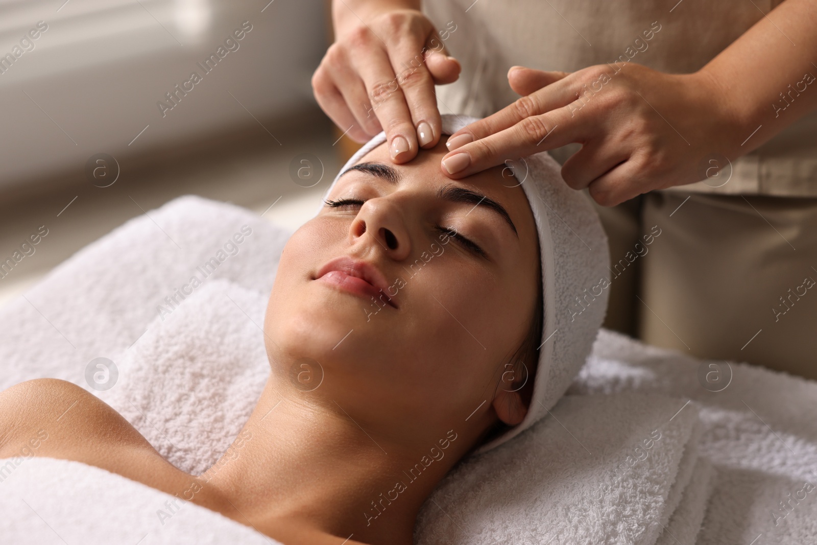 Photo of Attractive woman enjoying face massage, closeup. Beauty procedure