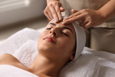 Photo of Attractive woman enjoying face massage, closeup. Beauty procedure