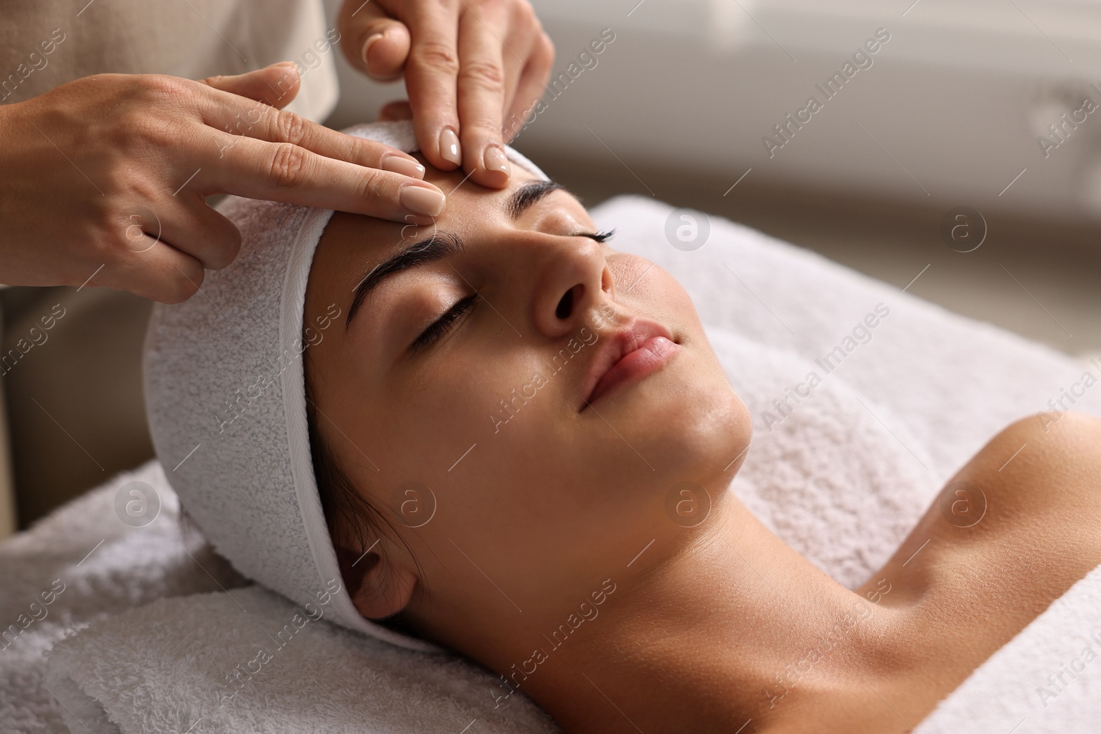 Photo of Attractive woman enjoying face massage, closeup. Beauty procedure