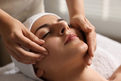 Photo of Attractive woman enjoying face massage, closeup. Beauty procedure